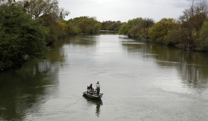 People fish in the Sacramento-San Joaquin River Delta's Elk Slough near Courtland, Calif., Tuesday, March 24, 2020. (AP Photo/Rich Pedroncelli, File)