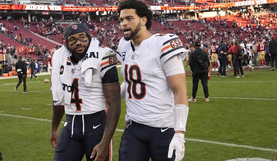 Chicago Bears running back D'Andre Swift (4) and quarterback Caleb Williams (18) walk off the field after an NFL football game against the San Francisco 49ers in Santa Clara, Calif., Sunday, Dec. 8, 2024. (AP Photo/Godofredo A. Vásquez)