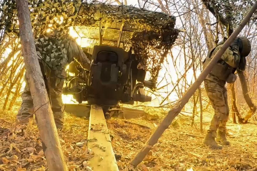 In this photo taken from a video released by Russian Defense Ministry press service on Wednesday, Dec. 11, 2024, Russian servicemen fire a D-20 howitzer toward Ukrainian positions in an undisclosed location. (Russian Defense Ministry Press Service via AP)