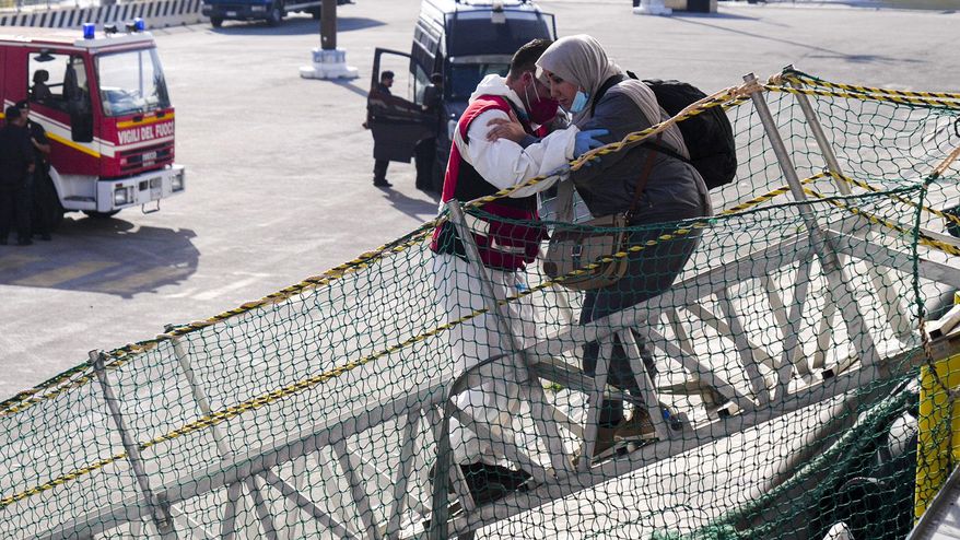A woman, one of some 258 people, including Syrians, Egyptians, Bangladeshi, and South Sudanese, saved from the sea in two different rescue operations on Friday is disembarked in Salerno, southern Italy, from the Doctors Without Borders search and rescue ship Geo Barents Monday, Oct. 9, 2023. (AP Photo/Paolo Santalucia, File)