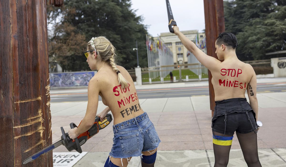 NextImg:Topless women protesting the Ukraine war are detained for vandalizing sculpture near U.N. building