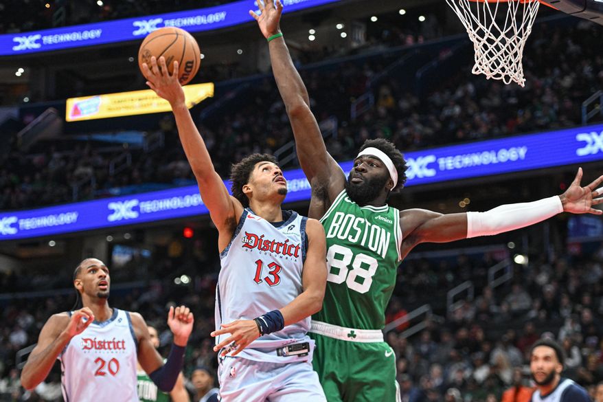 Washington Wizards guard Jordan Poole (13) putting up a shot over Boston Celtics center Neemias Queta (88) during the fourth quarter of an NBA game at Capital One Arena in Washington D.C., December 15, 2024. (Photo for the Washington Times)