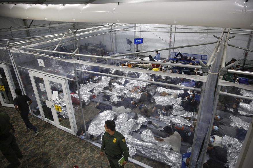In this March 30, 2021, photo, young minors lie inside a pod at the Donna Department of Homeland Security holding facility, the main detention center for unaccompanied children in the Rio Grande Valley run by U.S. Customs and Border Protection (CBP), in Donna, Texas. (AP Photo/Dario Lopez-Mills, Pool) **FILE**