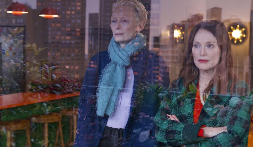 This image released by Sony Pictures Classics shows Julianne Moore, right, and Tilda Swinton in a scene from "The Room Next Door." (Sony Pictures Classics via AP)