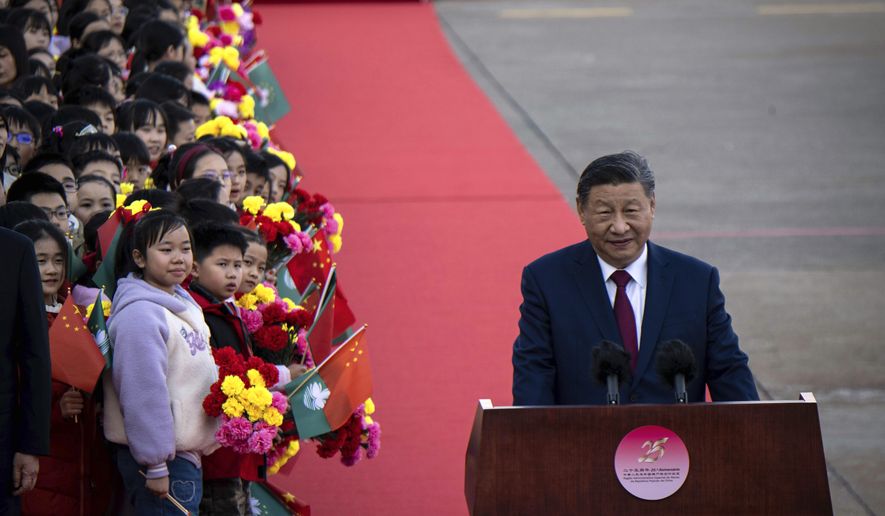 China's President Xi Jinping, right, speaks upon his arrival at the airport in Macao, China, Wednesday, Dec. 18, 2024, ahead of celebrations marking the 25th anniversary of the casino city’s return to Chinese rule. (Eduardo Leal/Pool Photo via AP)