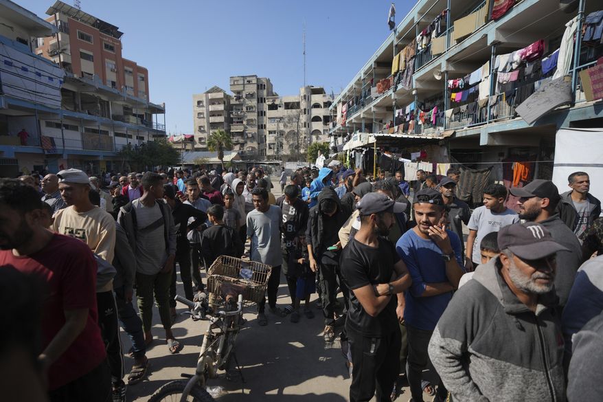 Palestinians gather to receive aid distributed by UNRWA, the U.N. agency helping Palestinian refugees, in Nusairat refugee camp, Gaza, on Nov. 5, 2024. (AP Photo/Abdel Kareem Hana) **FILE**