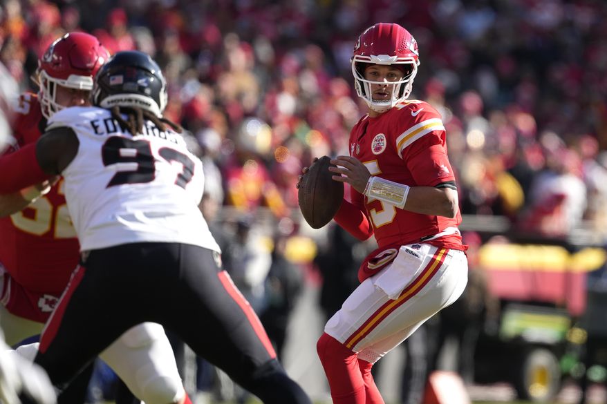 Kansas City Chiefs quarterback Patrick Mahomes drops back to pass during the first half of an NFL football game against the Houston Texans Saturday, Dec. 21, 2024, in Kansas City, Mo. (AP Photo/Ed Zurga)