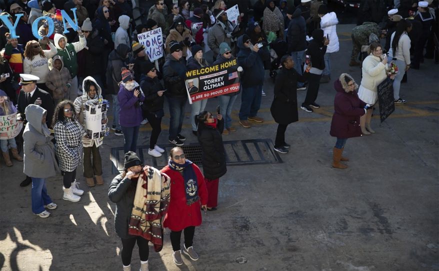 In this photo provided by the U.S. Navy, families wait for sailors to depart the USS Cole on Monday, Dec. 23, 2024, after returning to Naval Station Norfolk, Va., from a deployment. (Mass Communication Specialist Seaman Mark Peña/U.S. Navy via AP) **FILE**