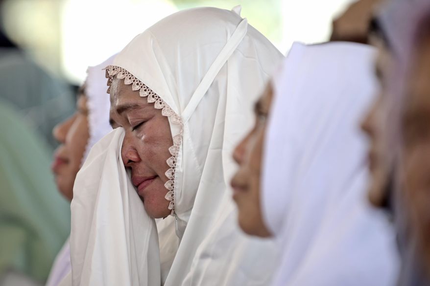 A woman weeps during a prayer marking 20 years of the massive Indian Ocean tsunami, in Banda Aceh, Indonesia, Thursday, Dec. 26, 2024. (AP Photo/Reza Saifullah)