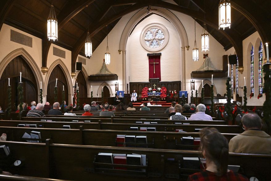 The congregation of Trinity United Church of Christ in Bethlehem, Pa., holds its last Christmas Eve service, Tuesday, Dec. 24, 2024. (Amy Shortell/The Morning Call via AP)