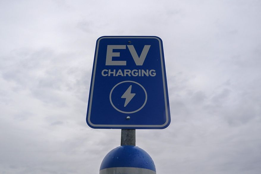 A sign is displayed at an electric vehicle charging station, March 8, 2024, in London, Ohio. (AP Photo/Joshua A. Bickel, File)