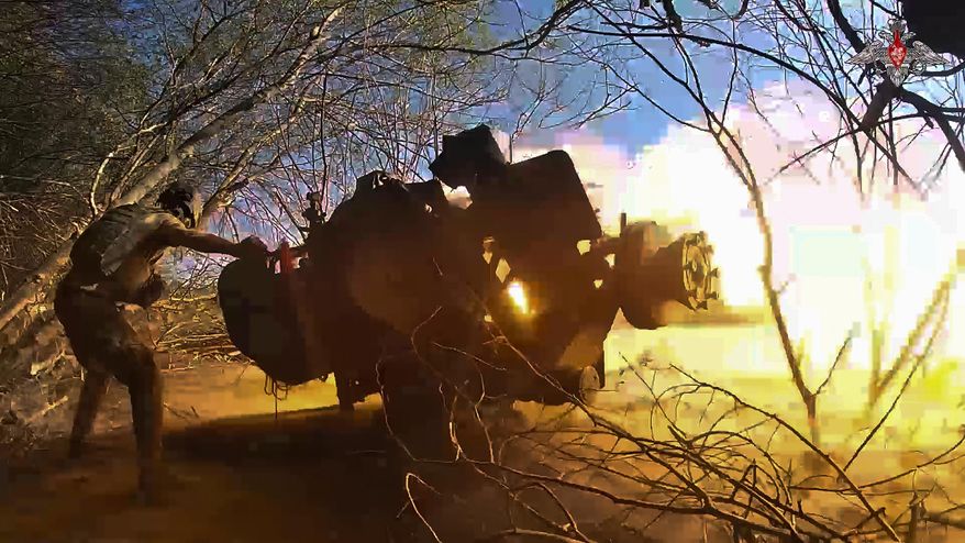 In this image from video released by the Russian Defense Ministry on Oct. 17, 2024, a Russian soldier fires a gun toward a Ukrainian position in the Russian-Ukrainian border area in the Kursk region, Russia. (Russian Defense Ministry Press Service photo via AP) **FILE**