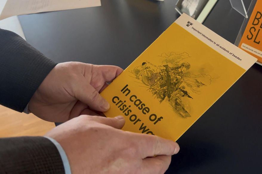Jan-Olof Olsson, Critical Infrastructure Protection (CIP) expert at the Swedish Civil Contingencies Agency (MSB) holds a yellow crisis preparedness brochure titled "In case of crisis or war", which was distributed to all Swedish households, Thursday, Dec. 26, 2024, in Karlstad, Sweden. (AP Photo/Mimmi Montgomery)
