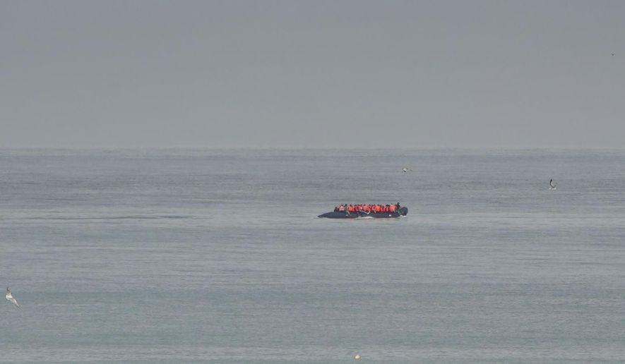 FILE- A boat thought to be with migrants is seen in the sea near the Wimereux beach, France, on Sept. 4, 2024. (AP Photo/Nicolas Garriga, File)