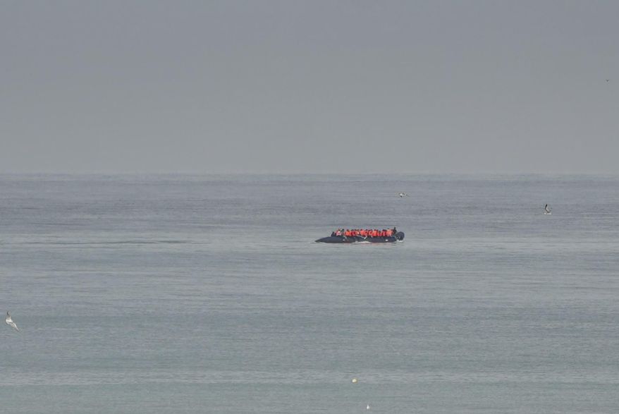 FILE- A boat thought to be with migrants is seen in the sea near the Wimereux beach, France, on Sept. 4, 2024. (AP Photo/Nicolas Garriga, File)
