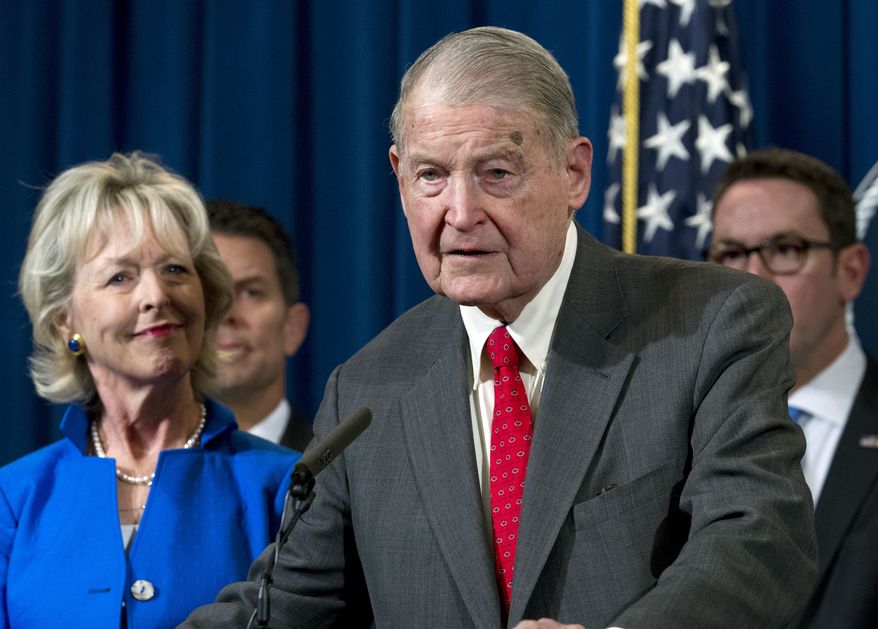 Former FBI director and CIA director William Webster accompanied by his wife Lynda Webster, who were targeted by a man who peddled a lottery scam over phone calls and emails, speaks during a news conference to address elder financial exploitation and law enforcement actions, at Department of Justice in Washington, Thursday, March 7, 2019. (AP Photo/Jose Luis Magana)
