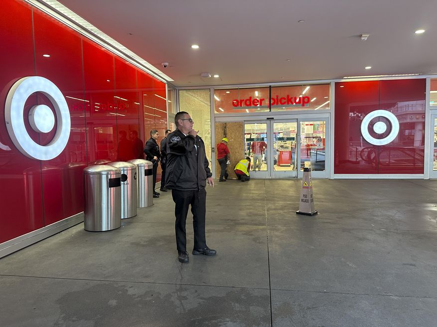 A security guard stands outside a Target store after two security guards were shot and wounded area after they confronted a man suspected of shoplifting in downtown Los Angeles on Tuesday, Dec. 31, 2024. (AP Photo/Damian Dovarganes)