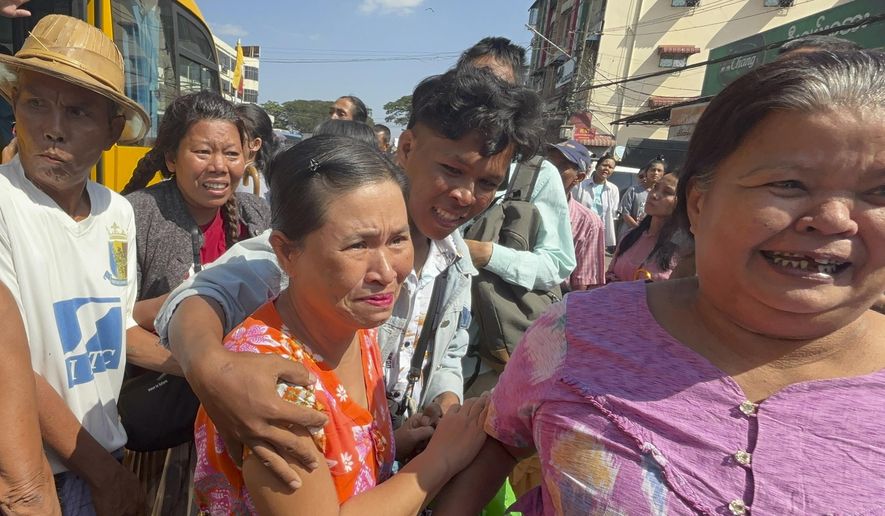 Released prisoners, front center and right, are welcomed by family members and colleagues outside Insein Prison Saturday, Jan. 4, 2025, in Yangon, Myanmar, as the military government has released more than 6,000 prisoners and has reduced other inmates’ sentences as part of a mass amnesty to mark the 77th anniversary of independence from Britain. (AP Photo/Thein Zaw)