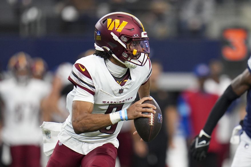 Washington Commanders quarterback Jayden Daniels looks to pass against the Dallas Cowboys during the first half of an NFL football game, Sunday, Jan. 5, 2025, in Arlington, Texas. (AP Photo/Josh McSwain)