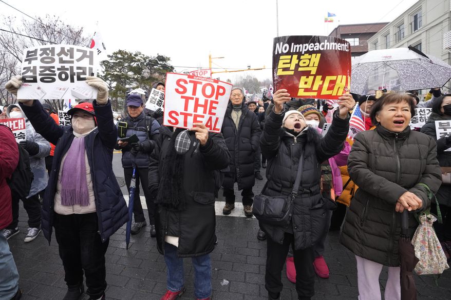 Supporters of impeached South Korean President Yoon Suk Yeol attend a rally to oppose his impeachment near the presidential residence in Seoul, South Korea, Sunday, Jan. 5, 2025. (AP Photo/Ahn Young-joon)