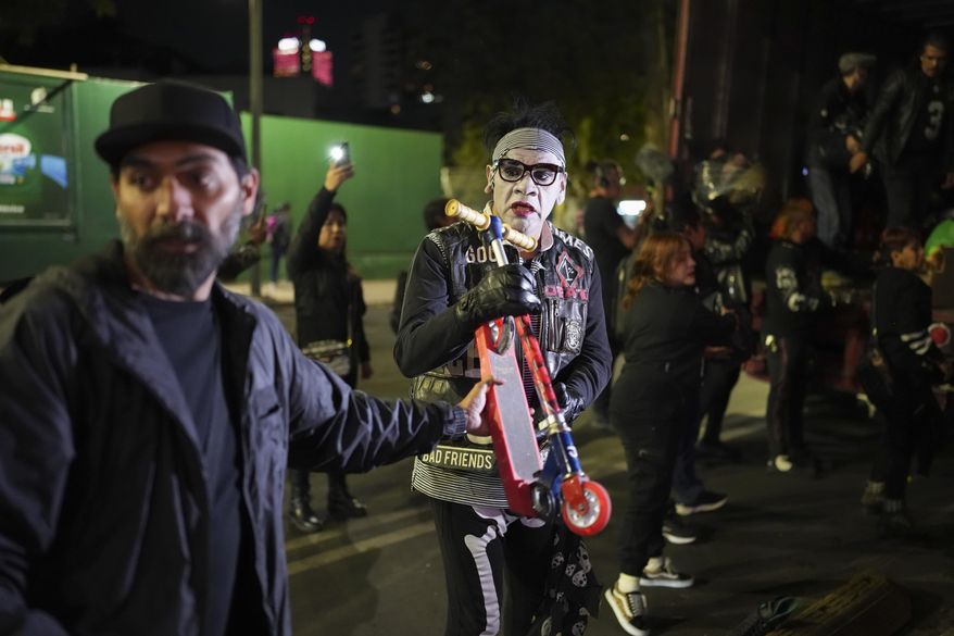 Volunteers known as The Punk Kings load a truck to distribute toys, clothes and pinatas to disadvantaged children in celebration of Epiphany, or Three Kings Day, in Mexico City, at night on Sunday, Jan. 5, 2025. (AP Photo/Eduardo Verdugo)