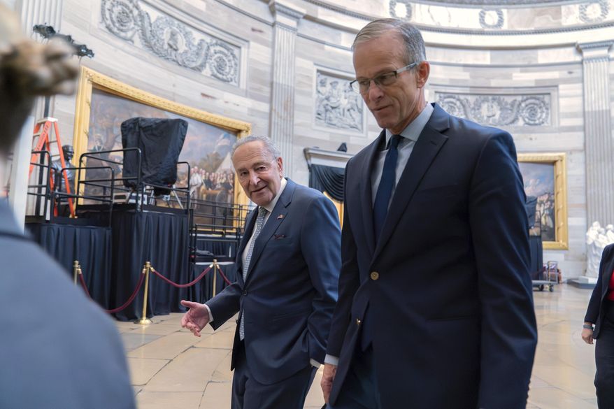 Senate Minority Leader Chuck Schumer, D-N.Y., left, and Senate Majority Leader John Thune, R-S.D., lead a Senate procession through the Rotunda to the House Chamber for a joint session of Congress to confirm the Electoral College votes, at the U.S. Capitol on Monday, Jan. 6, 2025, in Washington. (AP Photo/Jose Luis Magana) ** FILE **