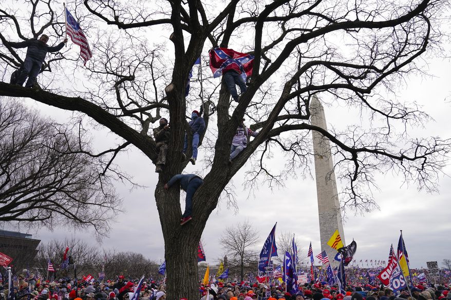 Supporters of then-President Donald Trump participate in a rally on Jan. 6, 2021 in Washington as Congress prepares to affirm President-elect Joe Biden’s victory. The same spot would provide a much different vista four years later, with snow — not protesters and tear gas — blanketing Washington as Congress convened to uneventfully certify Trump's win over Vice President Kamala Harris. (AP Photo/John Minchillo)