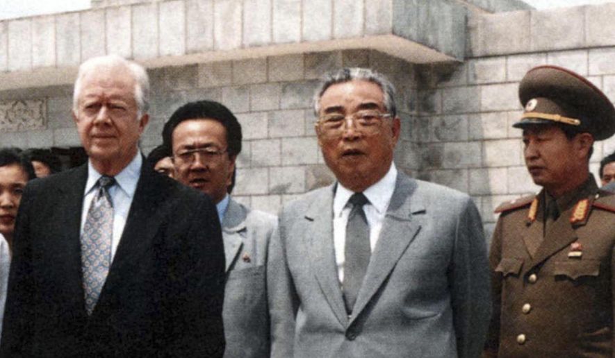 FILE - This photo provided by the North Korean government shows former U.S. President Jimmy Carter, left, and then North Korean President Kim Il Sung looking at the West Sea Barrage in Nampo, North Korea, on June 17, 1994. (Korean Central News Agency/Korea News Service via AP, File)