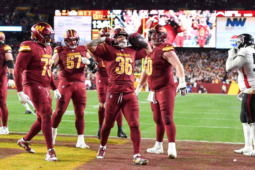 Washington Commanders running back Chris Rodriguez Jr. celebrating with teammates after running in for a touchdown during the fourth quarter of an NFL game against the Atlanta Falcons at Northwest Stadium in Landover, MD, December 29, 2024. (Photo for the Washington Times)