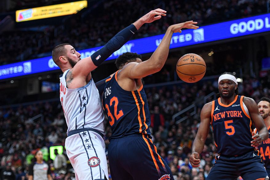 Washington Wizards center Jonas Valanciunas (17) reaching over New York Knicks forward Karl-Anthony Towns (32) for the ball during the fourth quarter of an NBA game at Capital One Arena in Washington D.C., December 30, 2024. (Photo for the Washington Times).