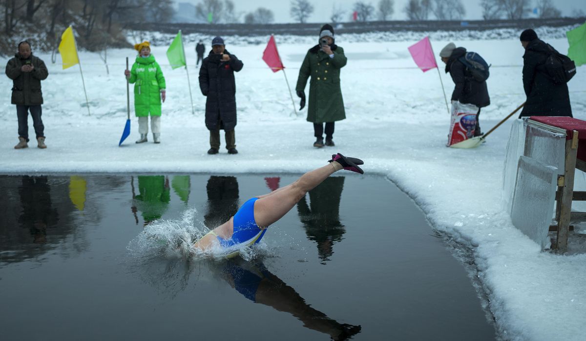 NextImg:In freezing temperatures, swimmers in China plunge into a river for health and joy