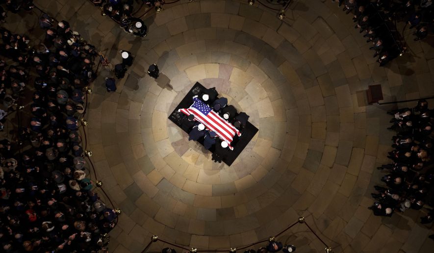 The flag-draped casket of former President Jimmy Carter lies in state at the rotunda of the U.S. Capitol Tuesday, Jan. 7, 2025, in Washington. (Andrew Harnik/Pool via AP)