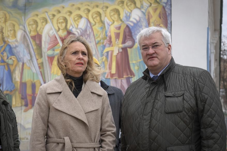 Iceland's Foreign Minister Thorgerdur Katrin Gunnarsdottir, left, and Ukraine's Foreign Minister Andriiy Sybiha stand at the entrance of St. Michael Monastery in Kyiv, Ukraine, Tuesday, Jan. 7, 2025. (AP Photo/Efrem Lukatsky)