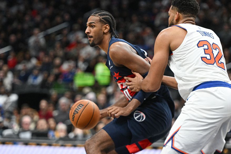 Washington Wizards center Alex Sarr (20) dribbling the ball while being guarded by New York Knicks forward Karl-Anthony Towns (32) during the fourth quarter of an NBA game at Capital One Arena in Washington D.C., December 28, 2024. (Photo for the Washington Times).