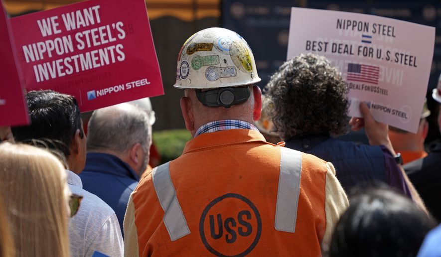 A rally by U.S. Steel employees is held outside the United Steel Tower in downtown Pittsburgh to display their support for the transaction with Nippon Steel, Wednesday, Sept. 4, 2024. (AP Photo/Gene J. Puskar)