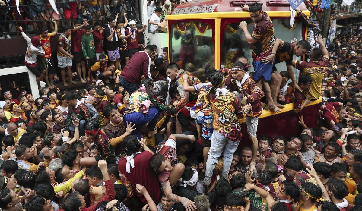 NextImg:Filipino Catholics pray for good health and peace in huge procession venerating Jesus statue