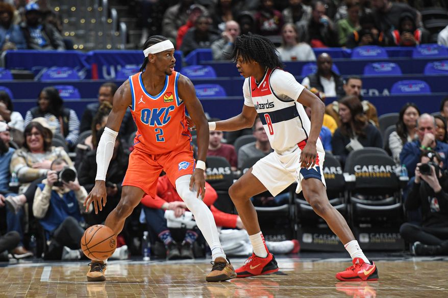 Oklahoma City Thunder guard Shai Gilgeous-Alexander (2) dribling the ball while being defended by Washington Wizards guard Bub Carrington (8) during the first quarter of an NBA game at Capital One Arena in Washington D.C., January 12, 2025. (Photo for the Washington Times)