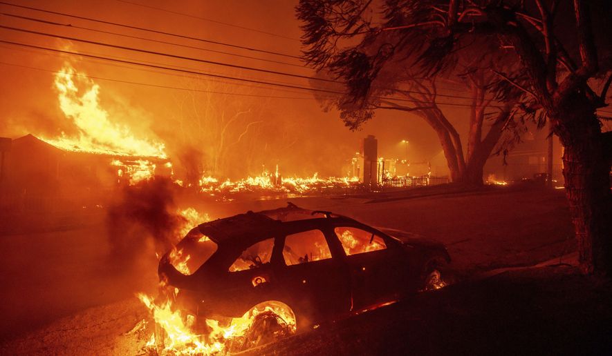 FILE - The Palisades Fire burns vehicles and structures in the Pacific Palisades neighborhood of Los Angeles, Jan. 7, 2025. (AP Photo/Ethan Swope, File)