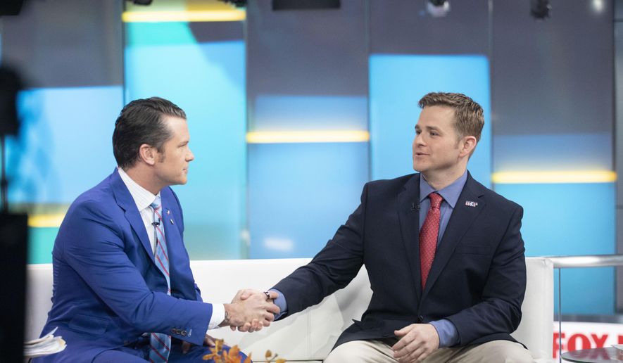 Pete Hegseth, left, with Fox News, shakes hands with Army 1st Lt. Clint Lorance during his appearance on "Fox & Friends," Nov. 18, 2019, in New York. President Donald Trump issued a full pardon Friday, Nov. 15, for Lorance, who had been convicted of murder for ordering his soldiers to fire upon three unarmed Afghan men in July 2012, killing two. (AP Photo/Mark Lennihan, File)