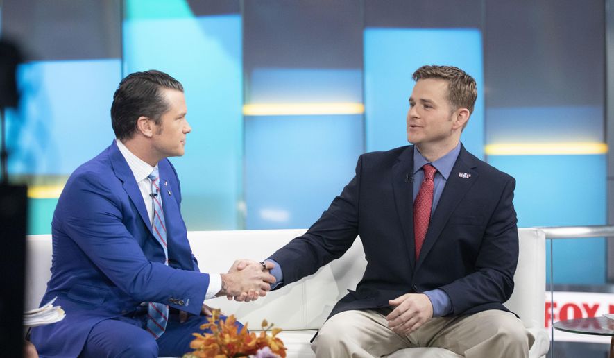 FILE - Pete Hegseth, left, with Fox News, shakes hands with Army 1st Lt. Clint Lorance during his appearance on "Fox & Friends," Nov. 18, 2019, in New York. President Donald Trump issued a full pardon Friday, Nov. 15 for Lorance, who had been convicted of murder for ordering his soldiers to fire upon three unarmed Afghan men in July 2012, killing two. (AP Photo/Mark Lennihan, File)