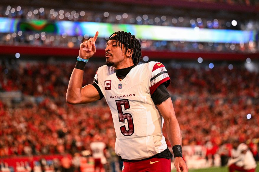 Washington Commanders quarterback Jayden Daniels (5) says a prayer prior to facing the Tampa Bay Buccaneers during Sunday Night Football at Raymond James Stadium in Tampa, Florida, January 12, 2025. (Photo by Brian Murphy for the Washington Times)