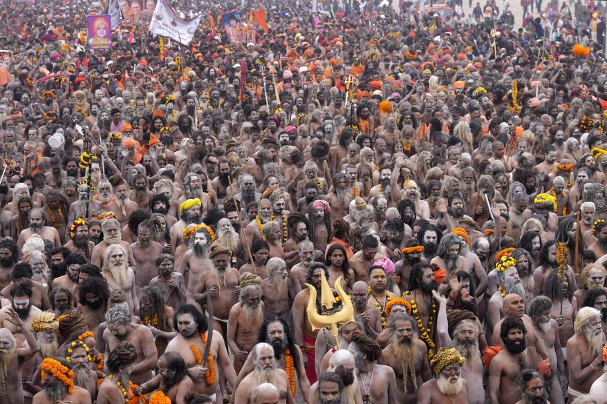 Naga Sadhus for ritualistic dips at Sangam, the confluence of the Rivers Ganges, Yamuna and mythical Saraswati on one of the most auspicious day Makar Sankranti, for the Maha Kumbh festival in Prayagraj, India, Tuesday, Jan. 14, 2025. (AP Photo/Rajesh Kumar Singh)