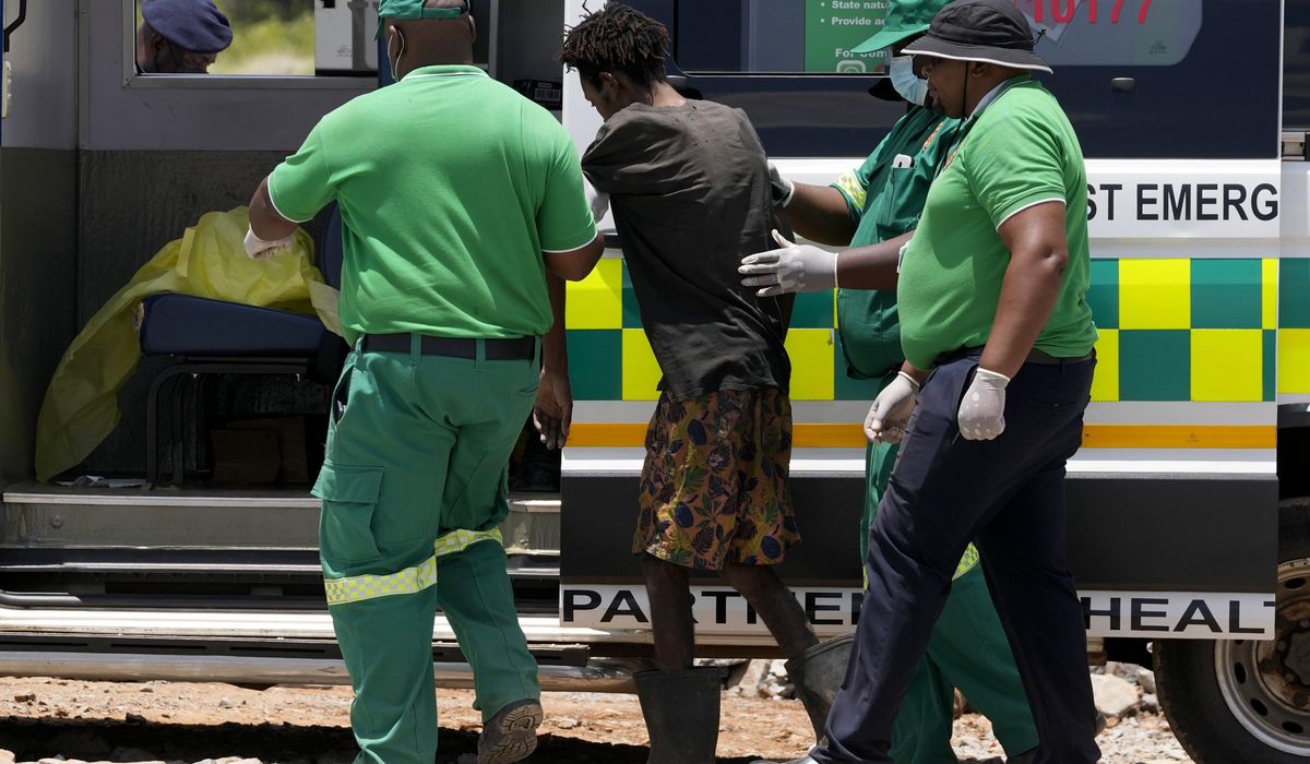 NextImg:Rescuers bring out survivors and dead from a South African mine as hundreds remain deep underground