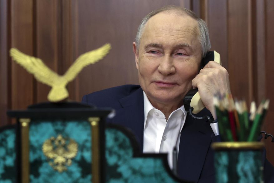Russian President Vladimir Putin speaks on the phone with Arina Porkhal, a 15-year-old girl from the Donetsk in Russian-controlled Donetsk region, as part of the New Year Tree of Wishes nationwide charity campaign, at the Kremlin in Moscow, Russia, Tuesday, Jan. 7, 2025. (Alexander Kazakov, Sputnik, Kremlin Pool Photo via AP)