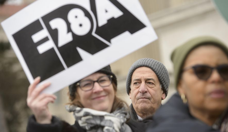 American Constitution Society President and former Senator Russell Feingold, center, joins others for a rally in front of the National Archives to highlight President Joe Biden's decision to declare the Equal Rights Amendment (ERA) as the 28th Amendment to the United States Constitution, Friday, Jan. 17, 2025, in Washington. (AP Photo/Rod Lamkey, Jr.)