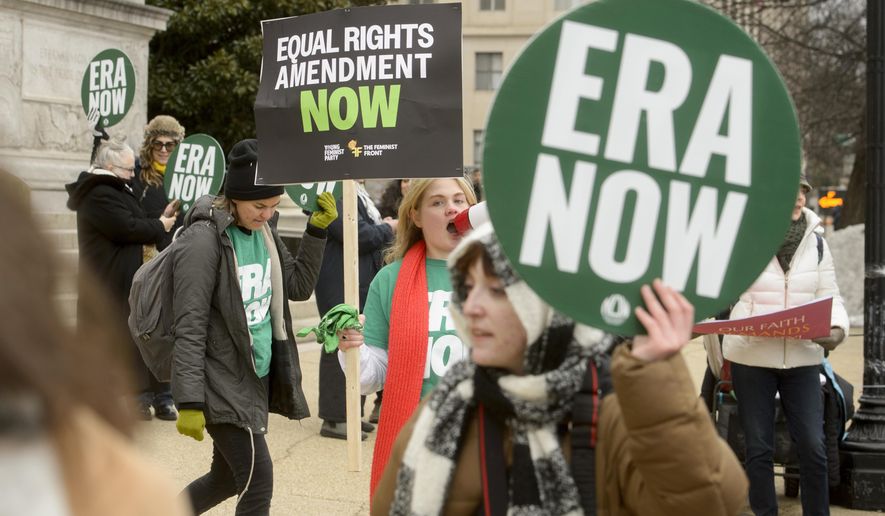 People hold a rally in front of the National Archives to highlight President Joe Biden's decision to declare the Equal Rights Amendment (ERA) as the 28th Amendment to the United States Constitution, Friday, Jan. 17, 2025, in Washington. (AP Photo/Rod Lamkey, Jr.)