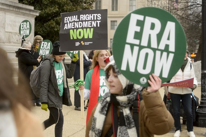 People hold a rally in front of the National Archives to highlight President Joe Biden's decision to declare the Equal Rights Amendment (ERA) as the 28th Amendment to the United States Constitution, Friday, Jan. 17, 2025, in Washington. (AP Photo/Rod Lamkey, Jr.)