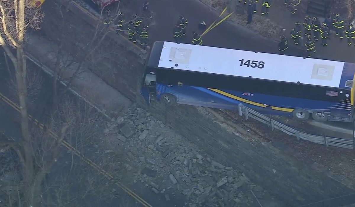 NextImg:Front of NYC bus left hanging near a Bronx overpass after accident