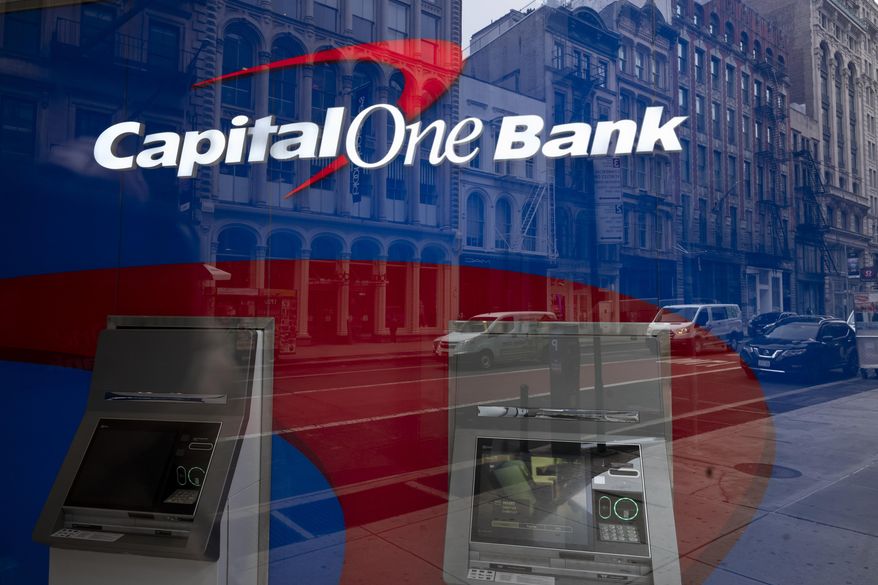 A Capital One Bank's ATM is shown, Thursday, March 25, 2021, in New York. (AP Photo/Mark Lennihan, File)