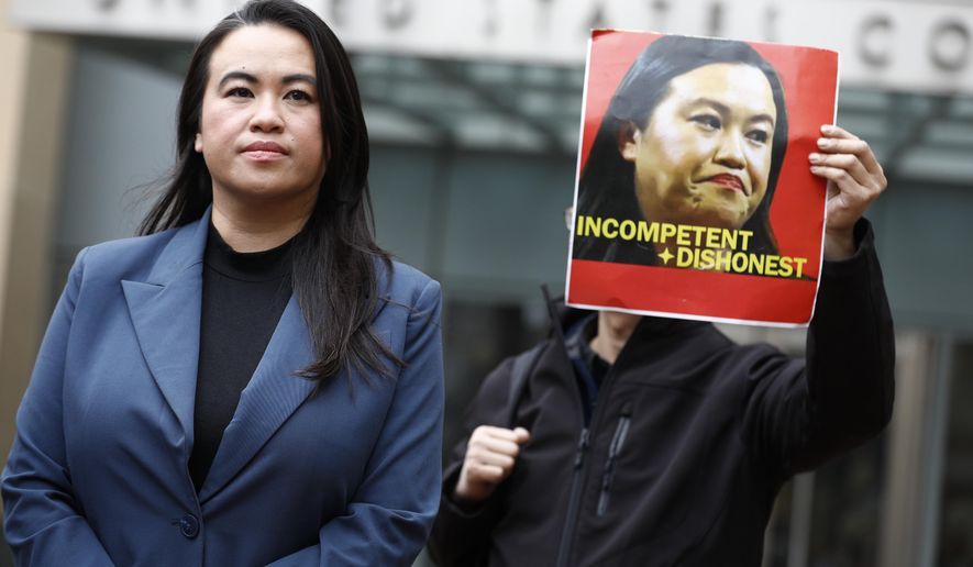 Former Oakland Mayor Sheng Thao stands in front of the United States District Court for a press conference following her arraignment of federal charges in Oakland, Calif., Friday, Jan. 17, 2025, as Tuan Ngo, founder of Asians Unite, protests at right. (Santiago Mejia/San Francisco Chronicle via AP)